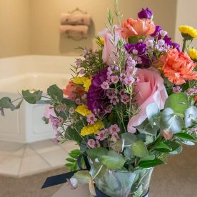 Flowers in front of a jetted tub