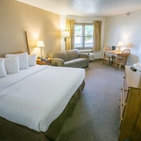 King Handicap accessible room with bed, couch, table and chairs
