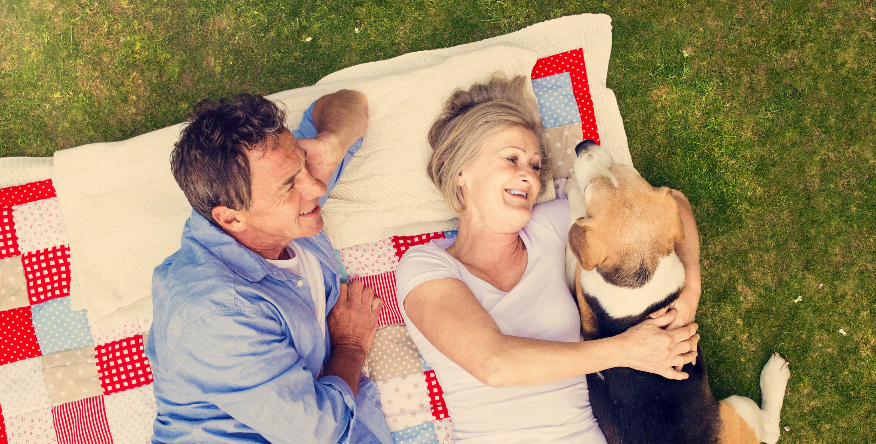 couple with dog on quilt